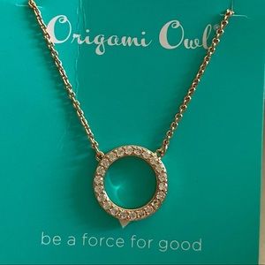 Rose-gold tone necklace with a circle pendent. Never worn.